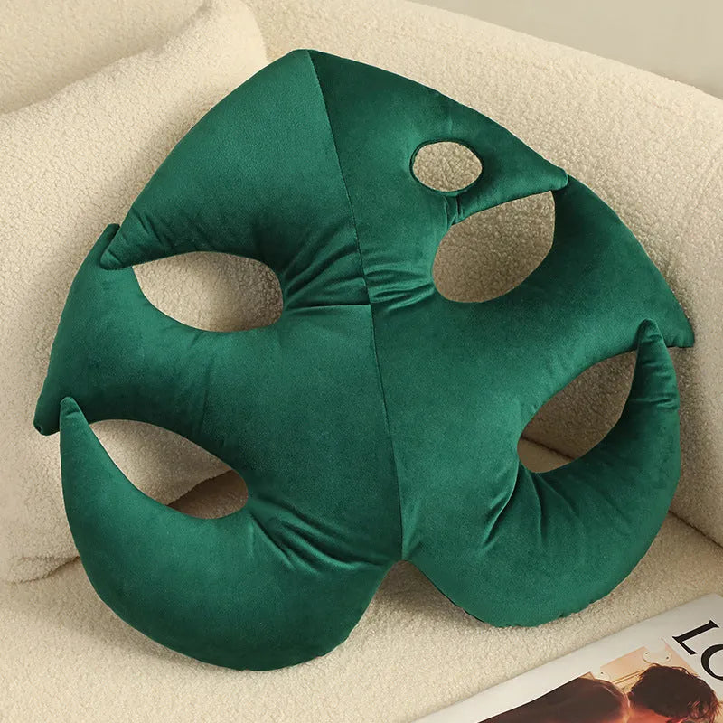 Green embroidered plant cushion with monstera leaf pattern on plush fabric