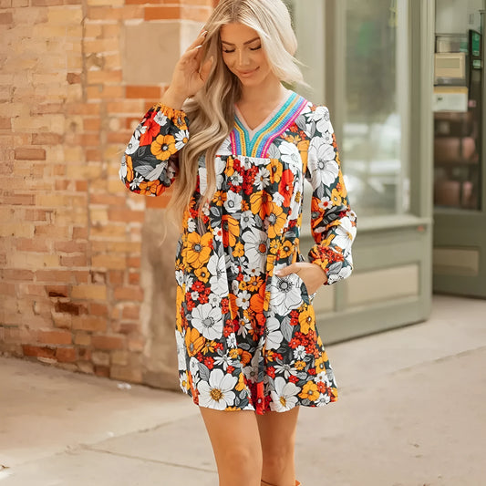 Orange floral print mini dress with striped lace detailing, V-neck collar, and long sleeves