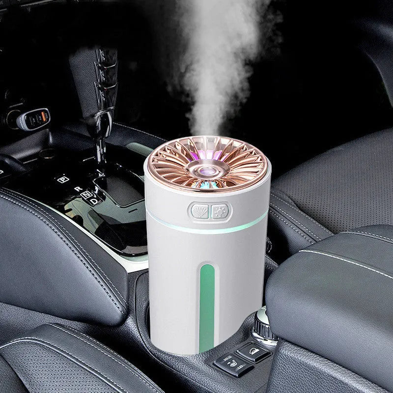 Black wireless car humidifier with colourful LED lights shown in vehicle cup holder