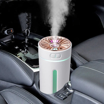 Black wireless car humidifier with colourful LED lights shown in vehicle cup holder