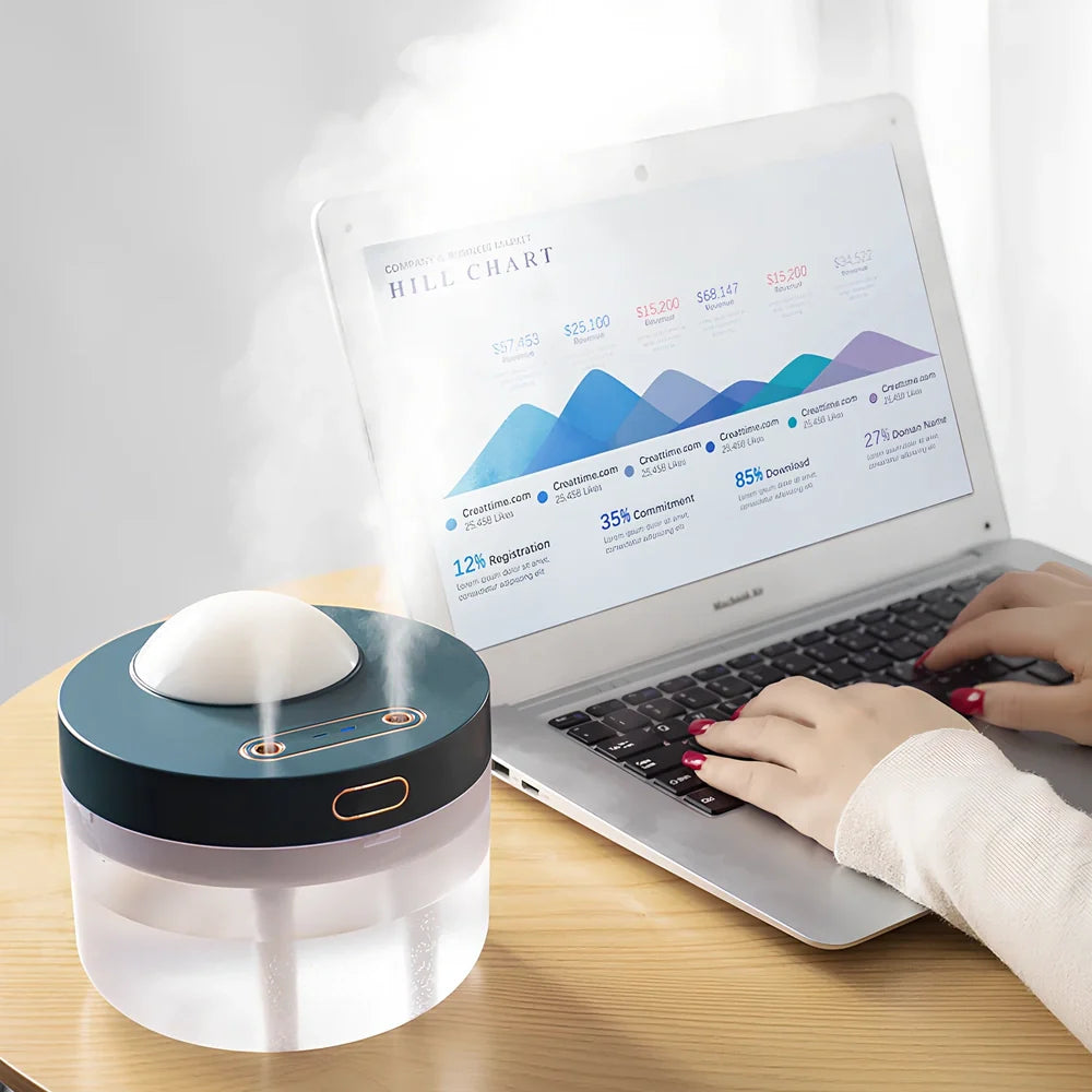 White portable humidifier with rotating projection light showing blue illumination and dual spray mist output