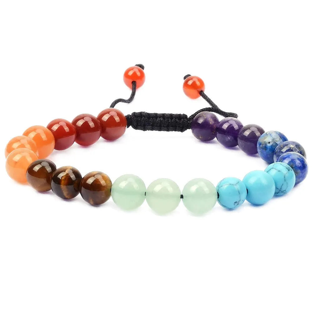 Close-up of a women's flat knot braided healing bracelet hand-woven with colourful gemstones.