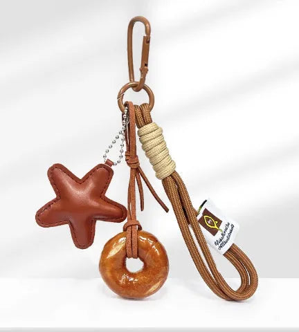 Handmade soda bread handbag pendant with cartoon croissant design on 30cm brown adjustable strap