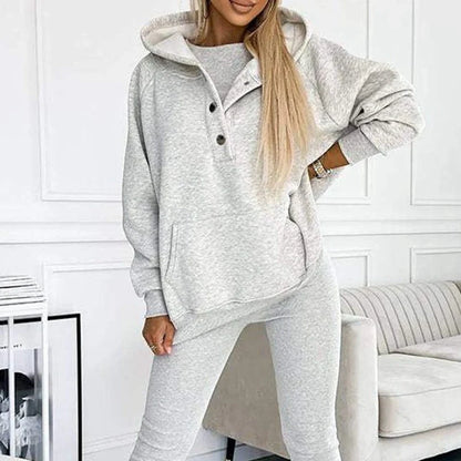 Women's 3-piece sports suit featuring a hooded sweatshirt with pockets and slim trousers