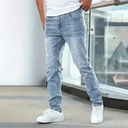 Men's black stretch jeans with straight leg skinny fit showing zipper fly and mid-rise waist