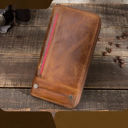 Men's brown genuine cowhide leather long wallet open to show card slots, RFID protection symbol, and zippered coin section.