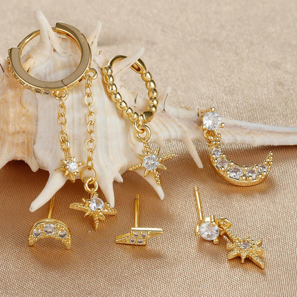 XINGX gold chain tassel earrings set showing six zircon stud earrings with dangling chain elements