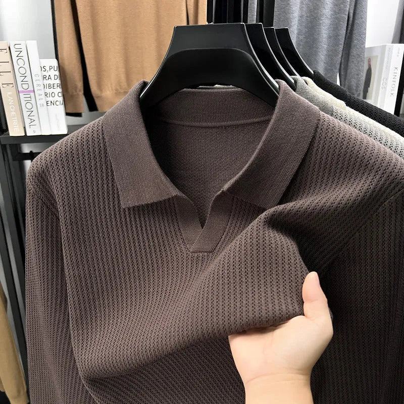 Man wearing a loose fit camel coloured pullover sweater, a casual autumn layer with a simple design.