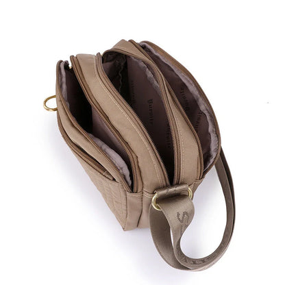 Casual women's crossbody messenger bag in nylon with polyester lining, available in multiple colors