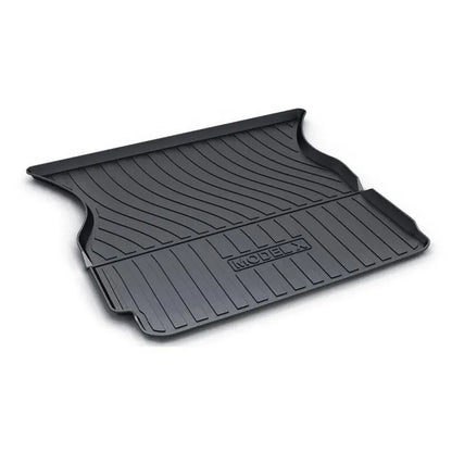 Black TPE rubber floor mats for Tesla Model 3, showing deep grooves and raised edges on driver's side.
