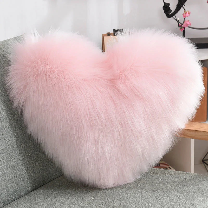 Cozy heart-shaped plush throw pillows in various colors and sizes for living room and bedroom decor