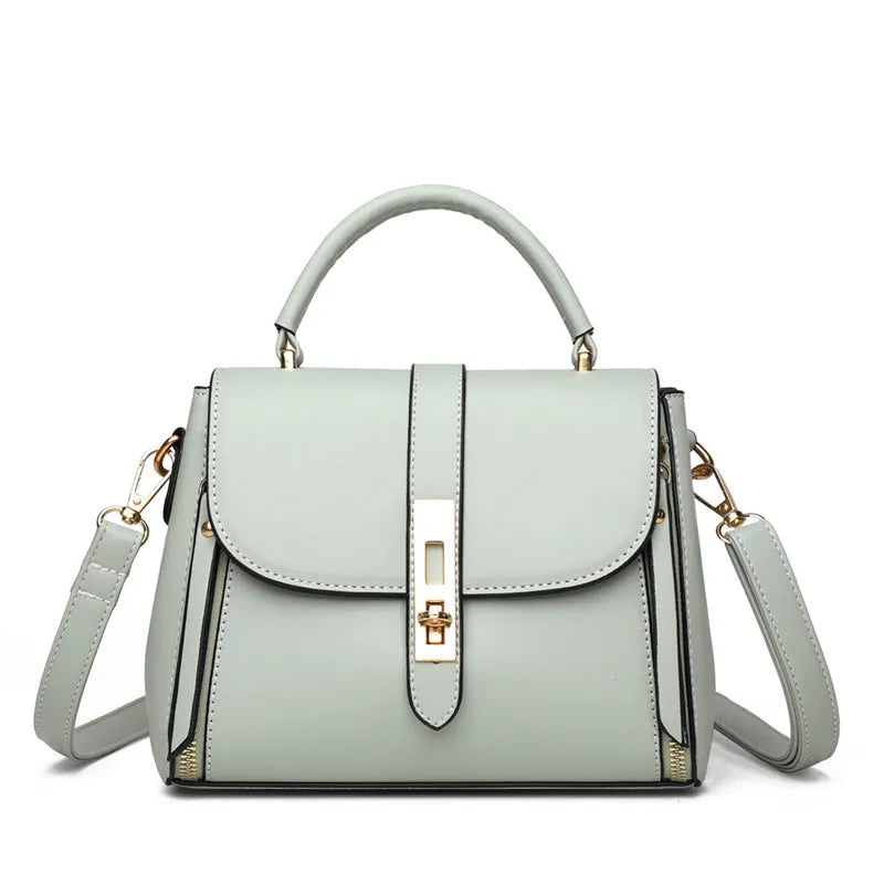 Women's soft black PU leather vertical messenger bag with adjustable strap, showing interior polyester lining.