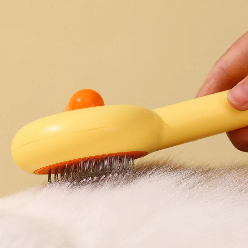 Small yellow duck-shaped pet grooming comb with needle pins and open section design