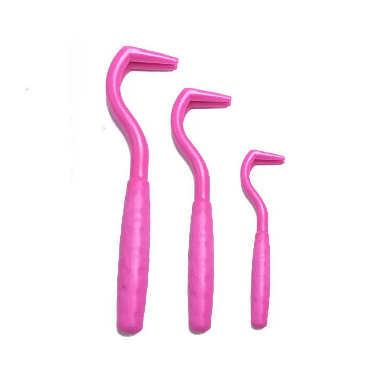 Set of three coloured tick hook removal tools for dogs on a white background.