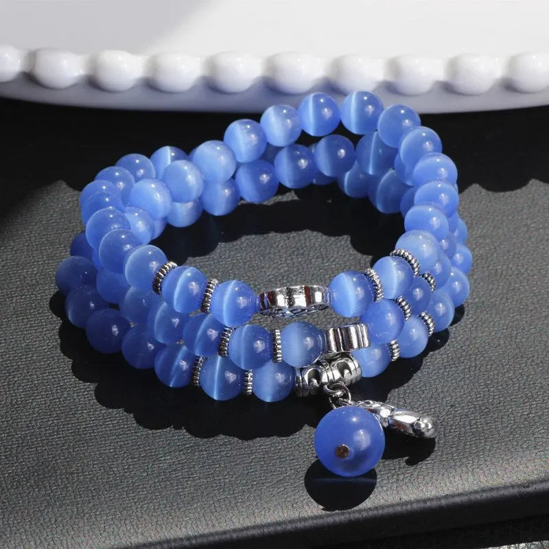 Women's opal crystal bracelet with lucky cat charm and geometric design, shown in blue colour option