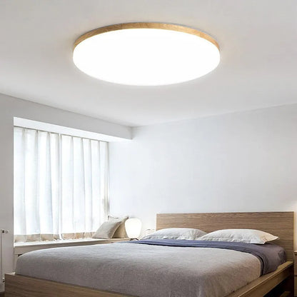 Japanese minimalist wooden and acrylic LED ceiling lamp with three-colour lighting on a white ceiling.