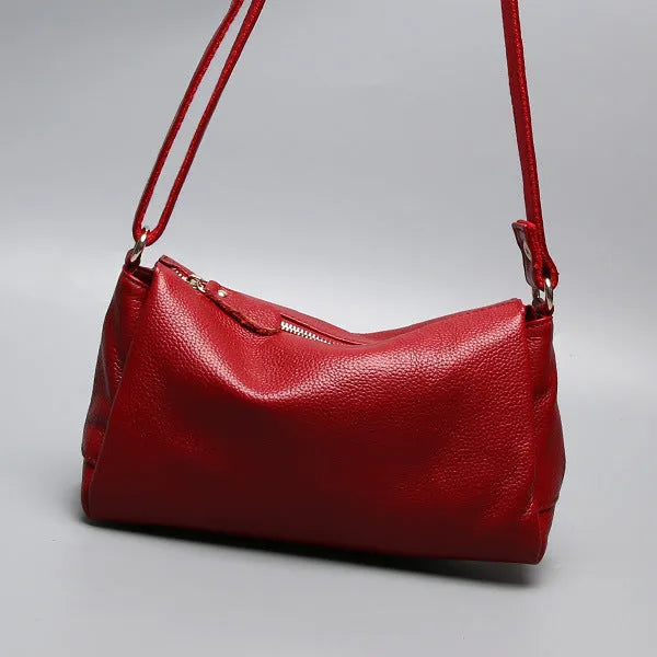 Soft genuine leather women's crossbody bag in horizontal square shape with single shoulder strap.