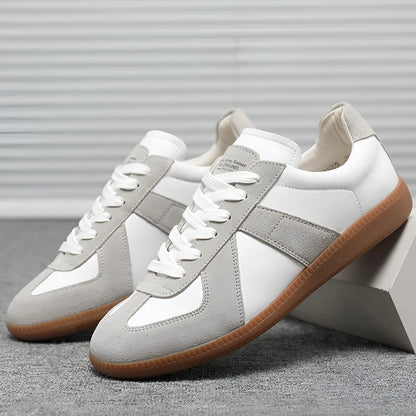 White Japanese-style retro low-top sneakers with round toe and flat rubber sole on a plain background.