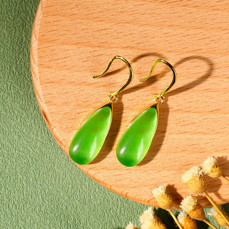 A pair of retro-style geometric copper earrings with water droplet details in a jade-toned electroplated finish.