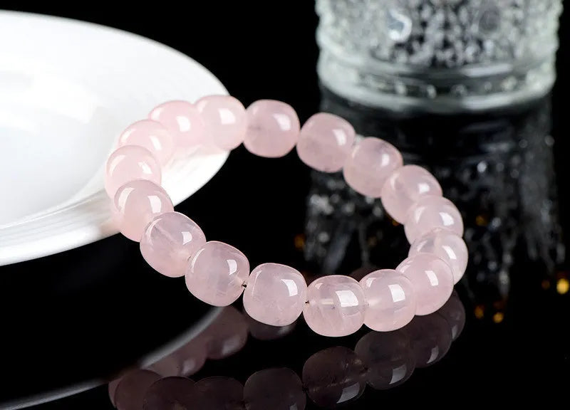 Pink crystal barrel bead bracelet with geometric design measuring 11-12mm beads on wrist