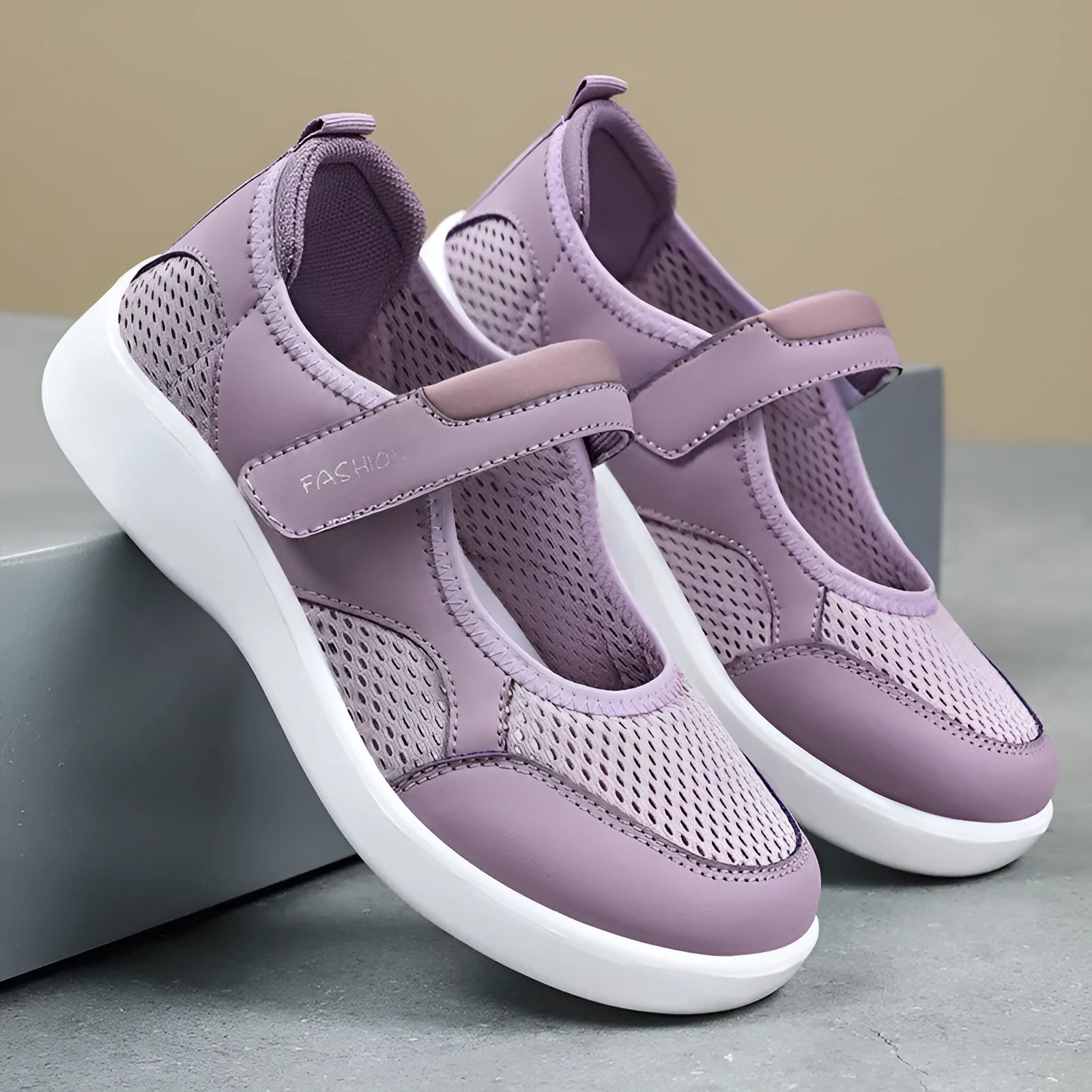 Women's grey velcro casual shoes with mesh upper and flat sole.