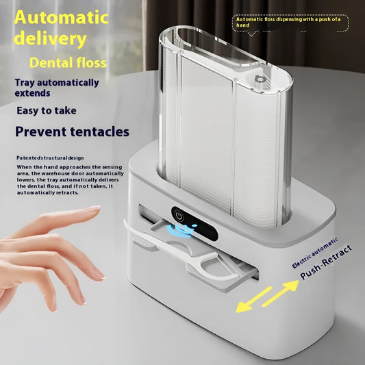 Dark grey automatic electric dental floss box with pop-up mechanism on a bathroom counter.