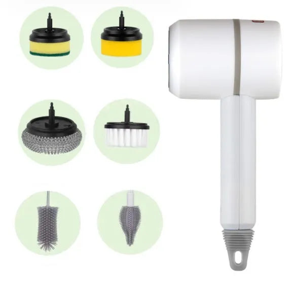 Green electric cleaning brush with scouring pad and brush heads on a kitchen worktop.