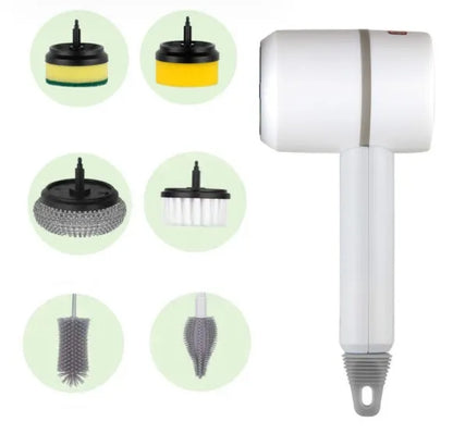 Green electric cleaning brush with scouring pad and brush heads on a kitchen worktop.