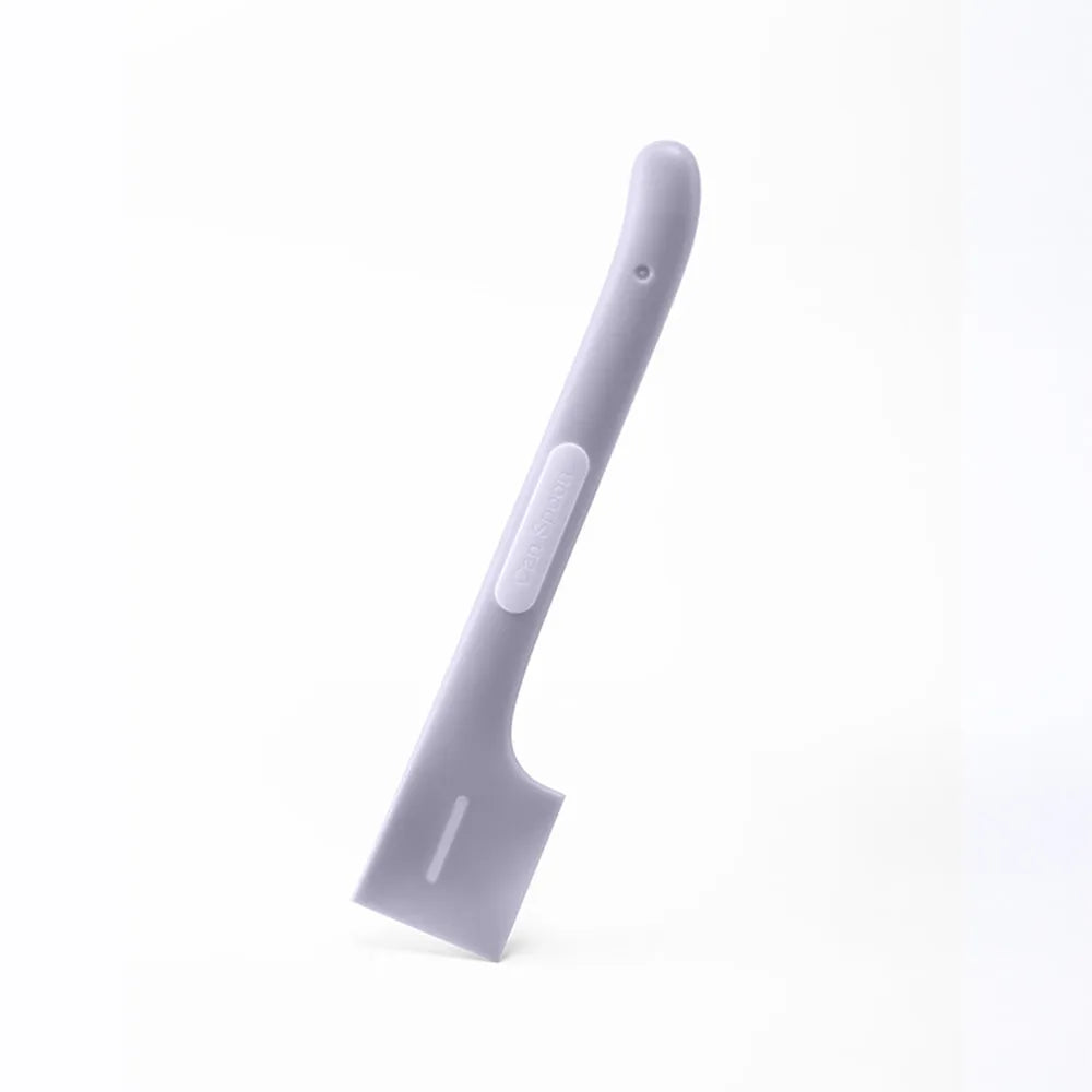 Green long-handled plastic spoon for scooping pet food from a can.
