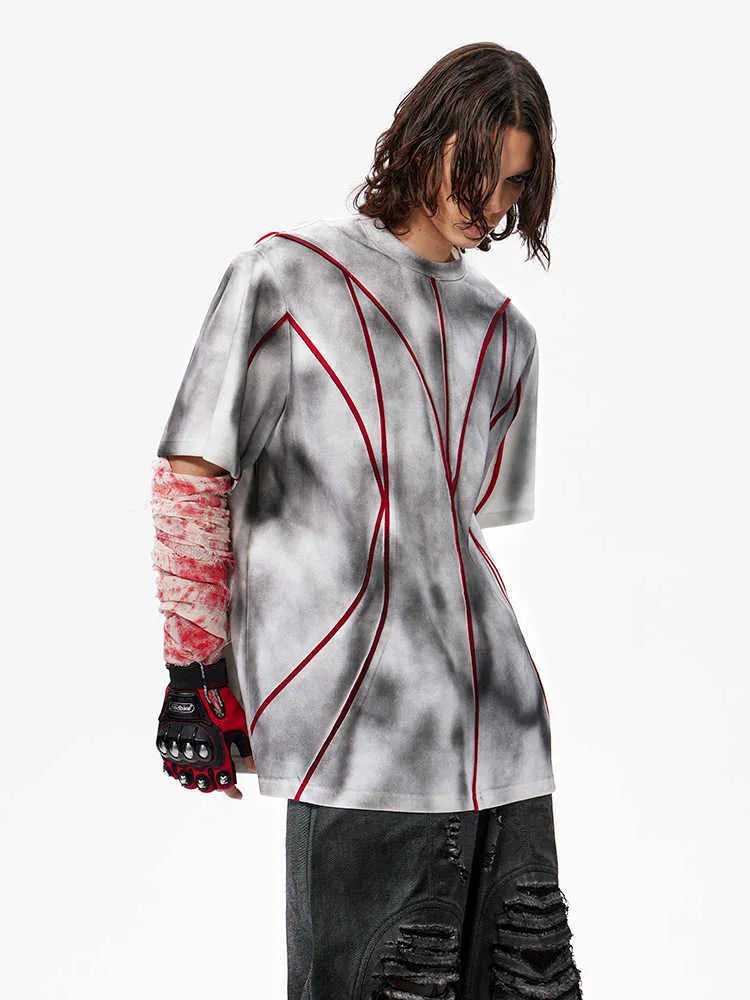 Padded shoulder short sleeve t-shirt with raised 3D line patchwork detailing on the front.