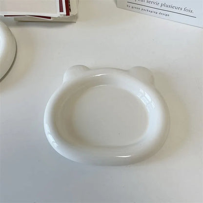 White porcelain plate with chubby toot bear design, shown in small 15cm and large 20cm sizes.