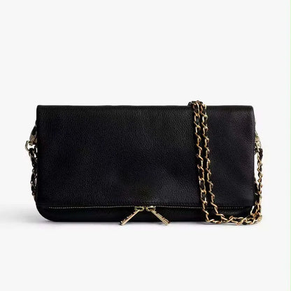 Soft black PU leather women's clutch bag with a gold chain strap, shown held and worn cross-body.
