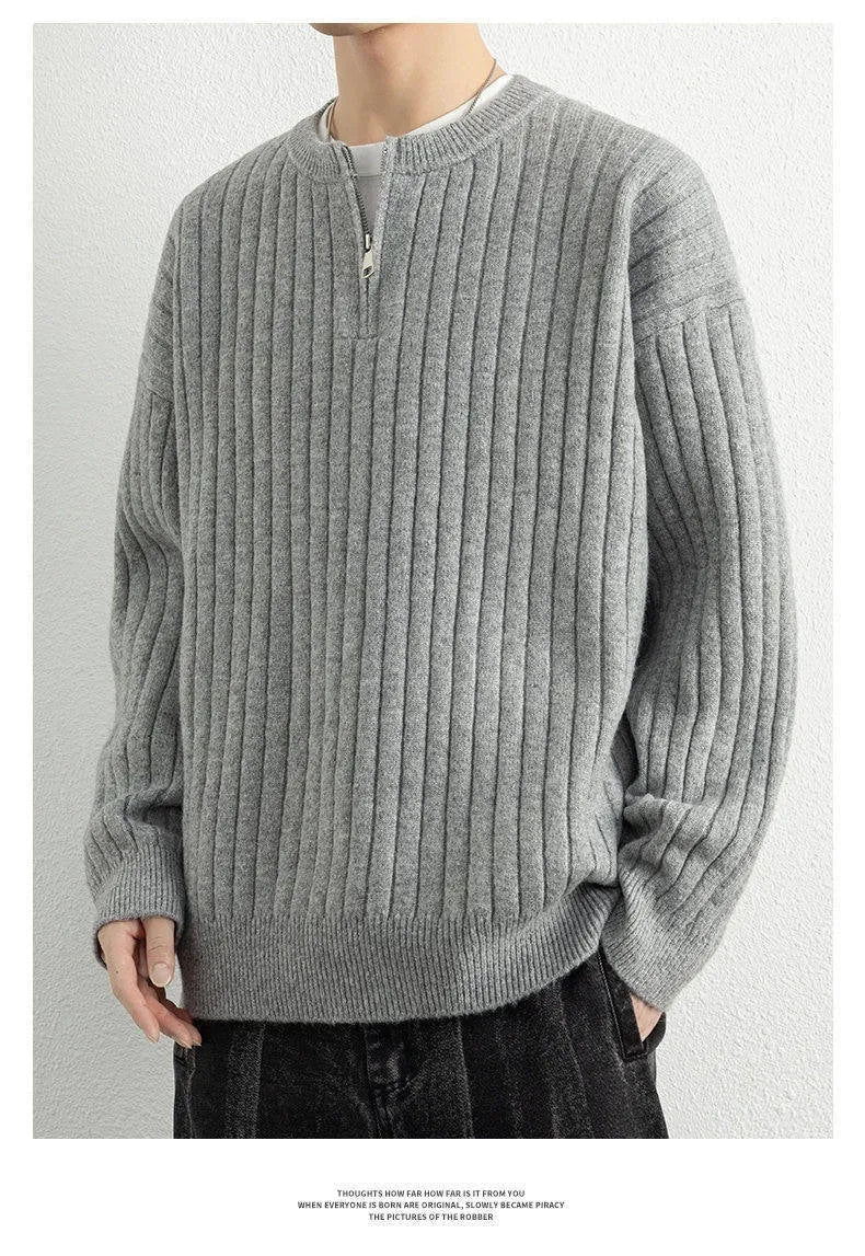 Men's grey half-zip pullover sweater with textured knit and loose fit, showing front view with zip partly open.
