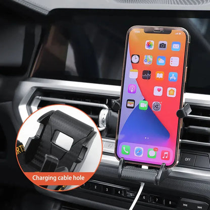 Gold car air vent phone holder with 360-degree rotation and silicone padding mounted on vehicle vent
