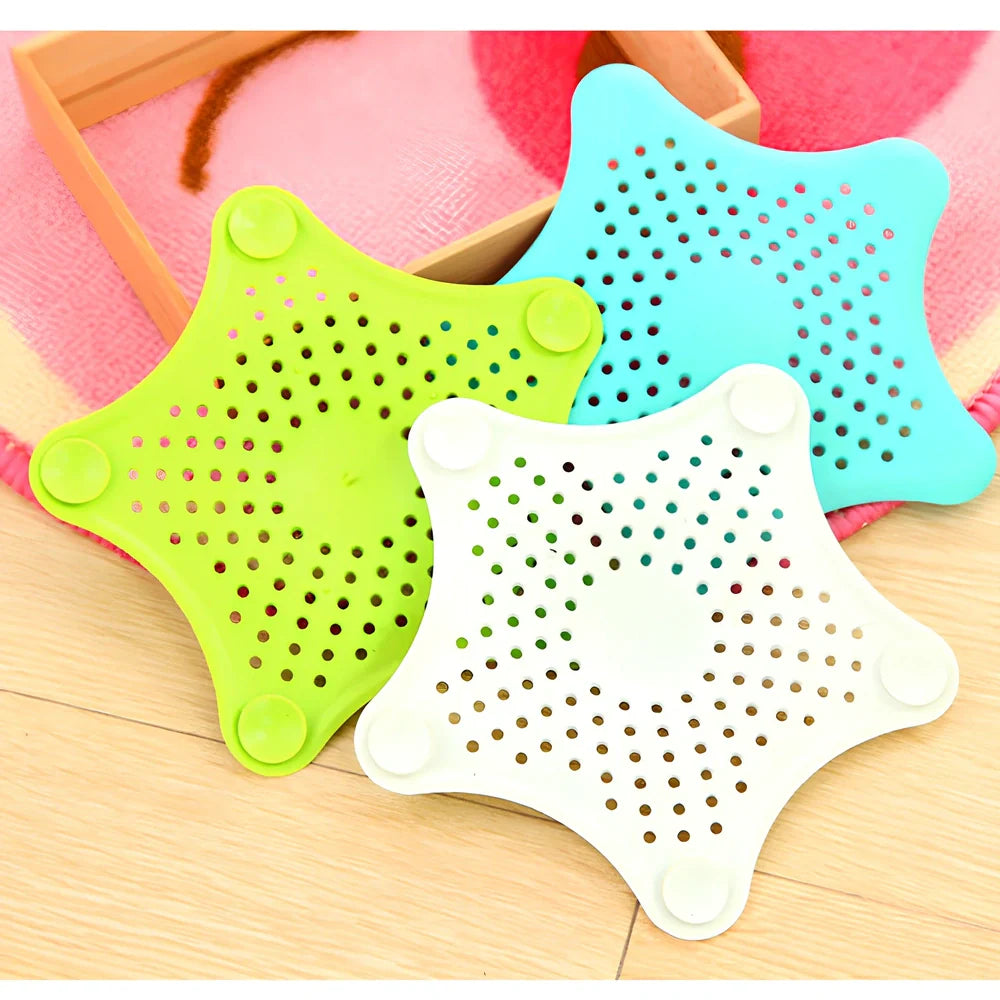 Three starfish-shaped sink drain filters in white, blue and green colours showing suction cups on bottom