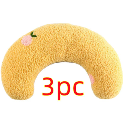 White U-shaped pet pillow measuring 27cm with raised rim supporting small cat's neck and back