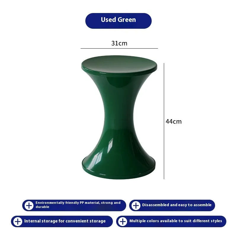Plastic hourglass-shaped shoe changing stool in green, 40cm high and 30cm wide