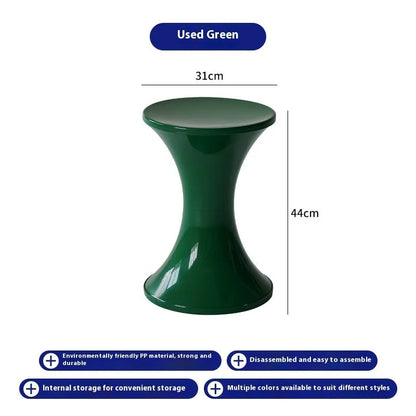 Plastic hourglass-shaped shoe changing stool in green, 40cm high and 30cm wide