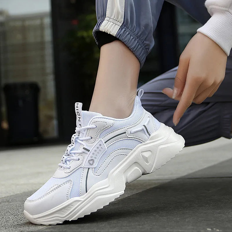 Women's white casual sports shoes with mesh upper, thick sole, buckle strap, and round toe.