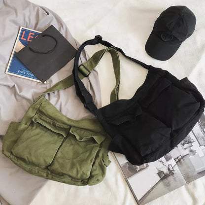 Canvas messenger bag in black, white, green, and brown with multiple pockets and adjustable strap