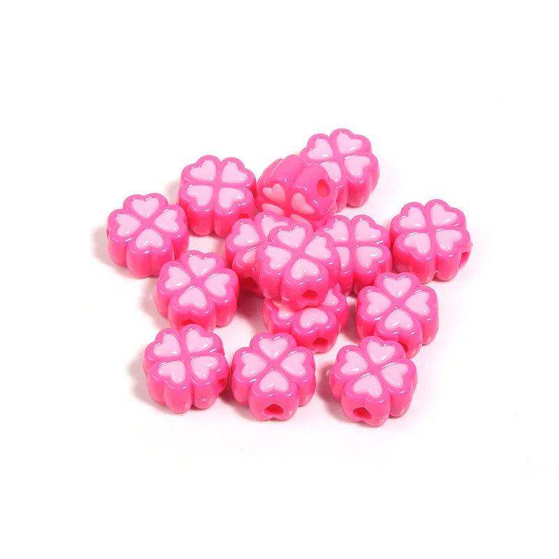 Assorted frosted acrylic four-leaf clover shaped beads in pink, green, and yellow, 15mm diameter.