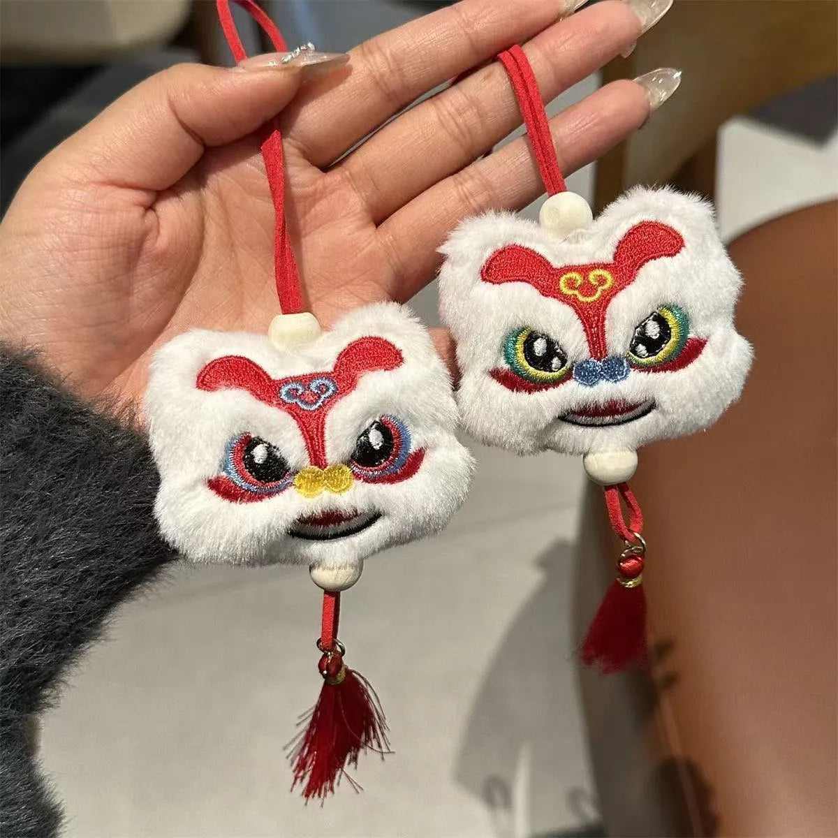 Blue and yellow Chinese style plush lion keychain ornament with star stone eyes and tassel.