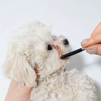 Black pet grooming brush with silicone bristles and plastic comb for dog and cat eye care.