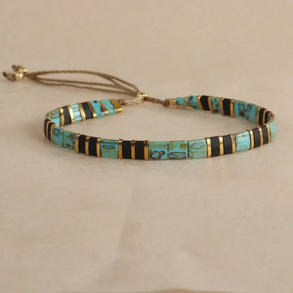 Adjustable pull beads glass bracelet in geometric shapes, shown in milky white colour.