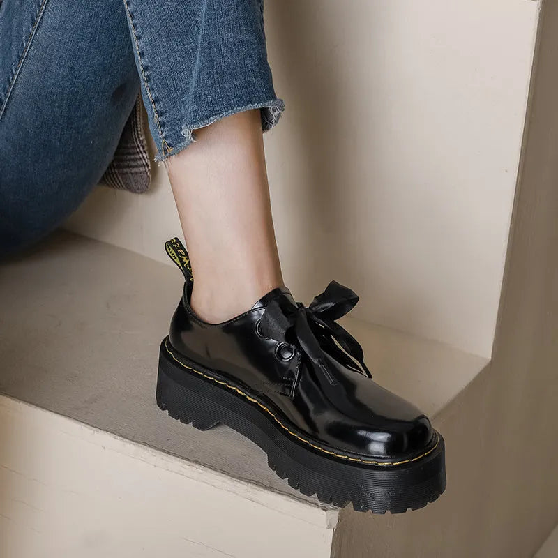 Women's black and white thick-soled leather shoes with cross-strap design and TPR tendon soles
