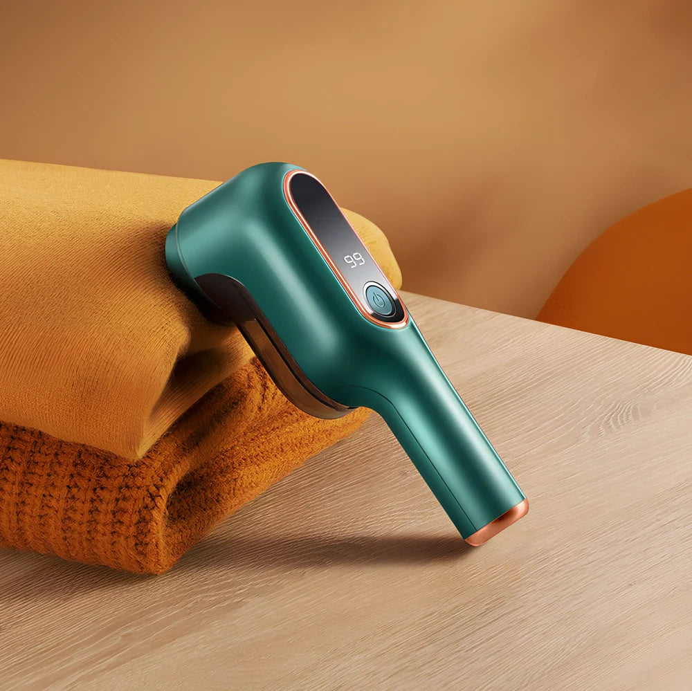 Rechargeable green lint trimmer removing fabric balls from wool jumper, digital display showing speed, 15 cm size with spare blades