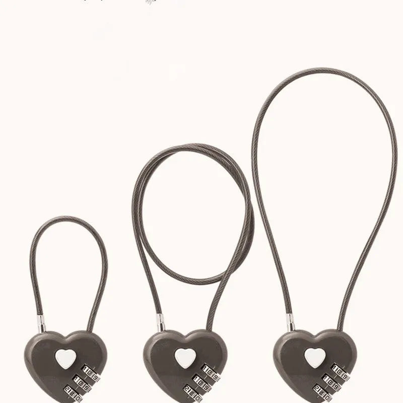 Peach heart-shaped ABS plastic bicycle helmet lock with a long steel cable, shown in various colours.