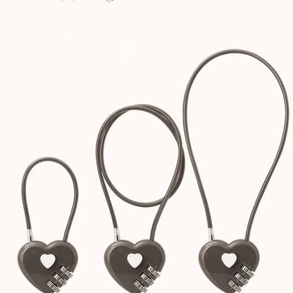 Peach heart-shaped ABS plastic bicycle helmet lock with a long steel cable, shown in various colours.