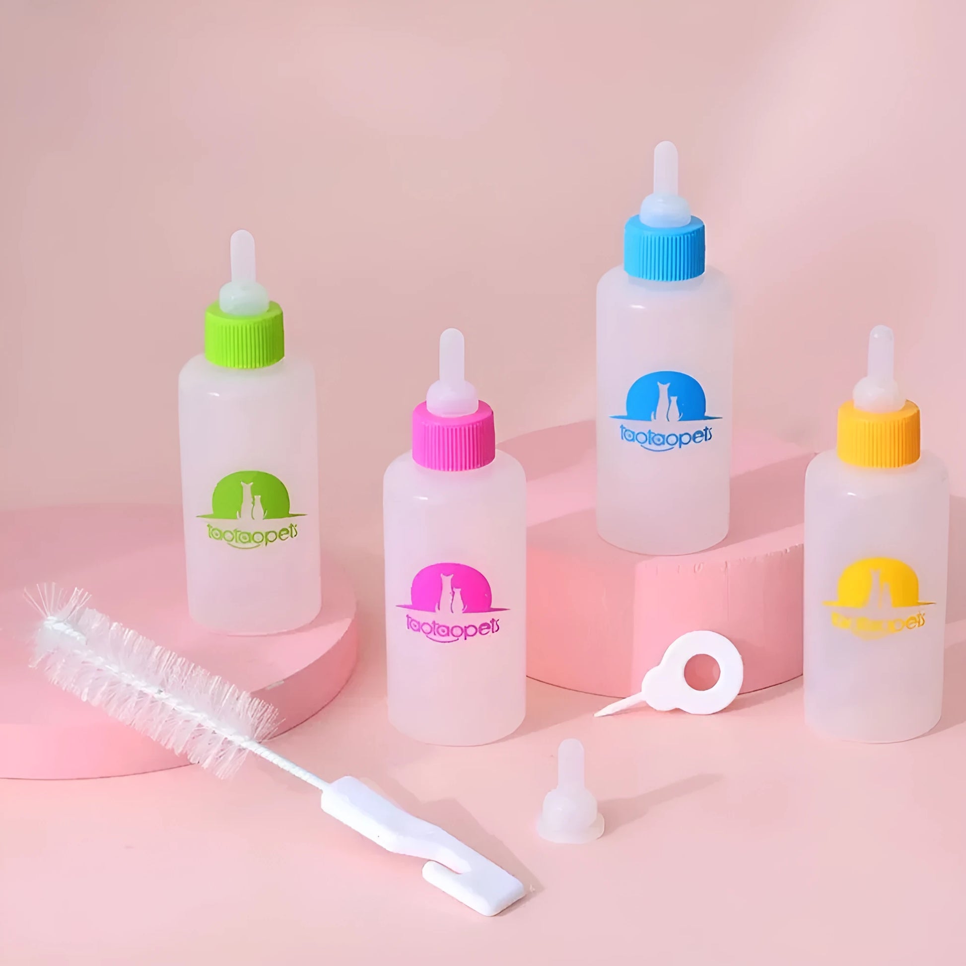Four pet milk bottles in blue, green, pink and yellow colours with cleaning brush for small animal feeding