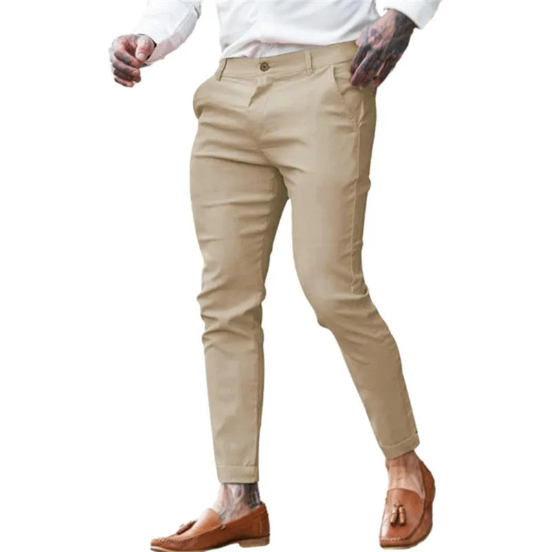 Men's slim fit elastic cotton pencil trousers in a solid colour on a hanger, showing the zip fly and mid waist design.